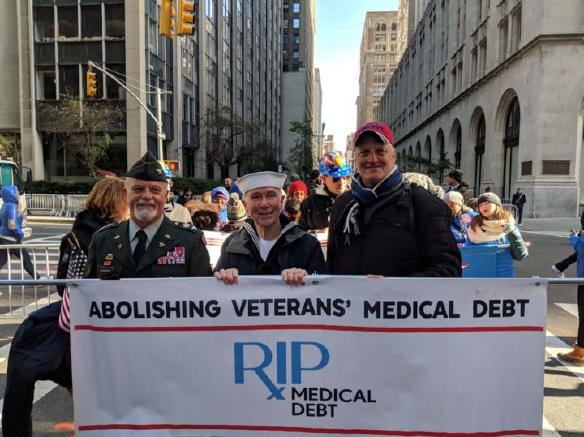 Pictured: Col (ret) US Army Mikel Burroughs, Jerry Ashton, Navy vet along with his RIP Medical Debt co-founder Craig Antico — NYC Veterans Day Parade 2017